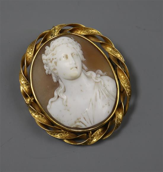 An early 20th century yellow metal mounted oval cameo brooch, carved with the bust of a lady, 46mm.